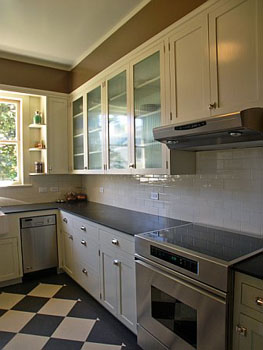 View of Kitchen with glass cabinet doors and apron sink